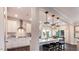 An open kitchen featuring white cabinets, a center island with seating, and modern stainless steel appliances at 1260 Hazelnut Ridge Ln, Knightdale, NC 27545