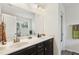 Bathroom featuring double sinks, white countertops, dark cabinets, and well-lit vanity area at 1620 Frog Hollow Way, Wake Forest, NC 27587