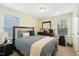 Well-lit bedroom featuring a plush queen-sized bed, wooden dresser, and neutral carpet at 1620 Frog Hollow Way, Wake Forest, NC 27587