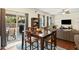 Open dining area with a wooden table, seating for four, and sliding doors to an outdoor patio at 1620 Frog Hollow Way, Wake Forest, NC 27587