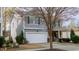 Two story home with light gray siding, dark shutters, a two car garage, and landscaping at 1620 Frog Hollow Way, Wake Forest, NC 27587