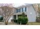 Two-story home with stone accents, a well-manicured lawn, and a welcoming front porch at 1620 Frog Hollow Way, Wake Forest, NC 27587