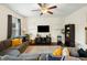 Comfortable living room featuring a sectional couch, ceiling fan, and a mounted television at 1620 Frog Hollow Way, Wake Forest, NC 27587