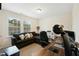 Office space with neutral walls, dark accent sofa, and large desk with plenty of natural light at 1620 Frog Hollow Way, Wake Forest, NC 27587