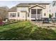 Large backyard with patio, outdoor dining, fire pit and lush green space at 1625 Heritage Garden St, Wake Forest, NC 27587