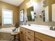 Bathroom with double vanity, soaking tub, and a separate shower at 1625 Heritage Garden St, Wake Forest, NC 27587