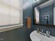 Stylish half bath with a modern sink, decorative mirror, and a window at 1625 Heritage Garden St, Wake Forest, NC 27587