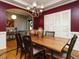 Well-appointed dining room with an archway view into the foyer, large table, and shuttered window at 1625 Heritage Garden St, Wake Forest, NC 27587