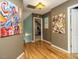 Well-lit hallway with hardwood floors and colorful artwork on the walls at 1625 Heritage Garden St, Wake Forest, NC 27587