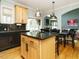 Kitchen island with granite countertop and seating overlooking a living room and dining area at 1625 Heritage Garden St, Wake Forest, NC 27587