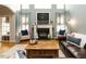 Bright living room featuring a cozy fireplace, high windows with lots of light, and a comfortable seating area at 1625 Heritage Garden St, Wake Forest, NC 27587