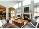 Open concept living room with vaulted ceiling, fireplace, and seamless access to the dining and kitchen areas at 1625 Heritage Garden St, Wake Forest, NC 27587