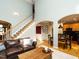 Spacious living room with staircase, open archway and seamless access to the kitchen and dining areas at 1625 Heritage Garden St, Wake Forest, NC 27587