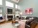 Spacious living room with high ceilings, fireplace, large windows, and comfortable leather seating at 1625 Heritage Garden St, Wake Forest, NC 27587