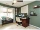 Inviting home office space with a wooden desk, comfortable seating, and natural light from the window at 1625 Heritage Garden St, Wake Forest, NC 27587