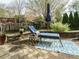 Cozy patio area with lounge chair, side table, and patterned rug, perfect for outdoor relaxation at 1625 Heritage Garden St, Wake Forest, NC 27587
