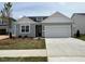 Charming single-story home featuring a manicured lawn and a two-car garage at 163 Little Creek Dr, Lillington, NC 27546