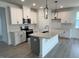 Modern kitchen with white cabinets, a center island, and stainless steel appliances at 163 Little Creek Dr, Lillington, NC 27546