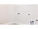 A bright laundry room includes washer/dryer hookups and a wire rack shelf at 163 Little Creek Dr, Lillington, NC 27546