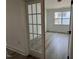 A well-lit room with paneled glass doors, hardwood floors and a window at 163 Little Creek Dr, Lillington, NC 27546
