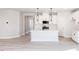Spacious open concept living area with hardwood floors that connect to the modern kitchen at 163 Little Creek Dr, Lillington, NC 27546