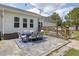 Backyard deck and stone patio featuring outdoor dining and seating area with string lights at 175 Brazil Nut Ln, Smithfield, NC 27577