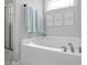 Bright bathroom features a soaking tub with decorative art and a shower with a glass enclosure at 175 Brazil Nut Ln, Smithfield, NC 27577