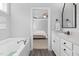Bright bathroom with a soaking tub and view into the main bedroom at 175 Brazil Nut Ln, Smithfield, NC 27577