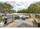 Outdoor deck with comfortable seating, a grill, and a view of the backyard; perfect for relaxing and entertaining at 175 Brazil Nut Ln, Smithfield, NC 27577