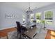 Sunlit dining area with wooden table, bench seating, and large windows overlooking a lush yard at 175 Brazil Nut Ln, Smithfield, NC 27577
