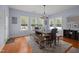 Bright dining area featuring a wooden table, bench seating, and large windows offering scenic outdoor views at 175 Brazil Nut Ln, Smithfield, NC 27577