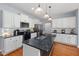 Modern kitchen features white cabinets, stainless steel appliances, granite counters and a large island at 175 Brazil Nut Ln, Smithfield, NC 27577