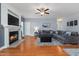 Spacious living room with a fireplace, a large comfortable sofa, and hardwood floors, perfect for relaxing and entertaining at 175 Brazil Nut Ln, Smithfield, NC 27577