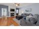Cozy living room with a fireplace, a ceiling fan, and comfortable seating, creating a warm and inviting space at 175 Brazil Nut Ln, Smithfield, NC 27577