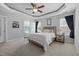 Spacious main bedroom featuring a tray ceiling, neutral tones, and an en-suite bathroom at 175 Brazil Nut Ln, Smithfield, NC 27577
