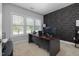 Functional home office featuring a large desk, geometric accent wall, and ample natural light at 175 Brazil Nut Ln, Smithfield, NC 27577