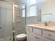 Clean bathroom with a glass shower, white cabinets, and vanity at 176 Golfview Ave, Benson, NC 27504