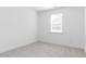 Clean and simple bedroom featuring neutral carpet, white walls, and a large window for ample natural light at 176 Golfview Ave, Benson, NC 27504
