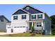 Stylish two-story home with a three-car garage and inviting front porch on a well-manicured lawn at 176 Golfview Ave, Benson, NC 27504