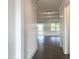 Inviting hallway with dark wood floors and white walls leads to a bright living space filled with natural light at 176 Golfview Ave, Benson, NC 27504