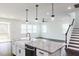 Modern kitchen island with granite countertops, pendant lighting, and stainless steel appliances at 176 Golfview Ave, Benson, NC 27504