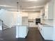 Kitchen featuring a large island with granite countertops, stainless steel appliances, and white cabinets at 176 Golfview Ave, Benson, NC 27504