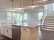 Kitchen featuring a large island with granite countertops, stainless steel appliances, and white cabinets at 176 Golfview Ave, Benson, NC 27504