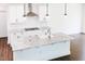 Bright kitchen features white cabinets, granite countertops, and a stylish stainless steel range hood at 176 Golfview Ave, Benson, NC 27504