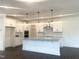 Kitchen featuring a large island with granite countertops, stainless steel appliances, and white cabinets at 176 Golfview Ave, Benson, NC 27504