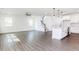 Open-concept living room with hardwood floors, staircase, and open kitchen at 176 Golfview Ave, Benson, NC 27504