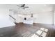 Open floor plan with kitchen island, luxury vinyl plank flooring, and natural light at 176 Golfview Ave, Benson, NC 27504