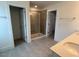 Bathroom featuring a glass-enclosed walk-in shower, double sinks, tile floor, and a separate toilet room for added privacy at 183 Little Crk Dr, Lillington, NC 27546