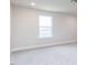 Bedroom features neutral walls and carpet and a single window at 183 Little Crk Dr, Lillington, NC 27546