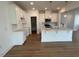 Modern, bright kitchen with white cabinets, stainless steel appliances, and a large island with pendant lighting at 183 Little Crk Dr, Lillington, NC 27546